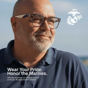 Man wearing glasses and a navy shirt with U.S. Marine Corps logo and text.