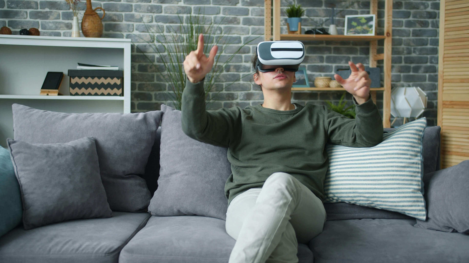 Person using a VR headset on a couch in a living room setting