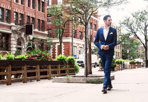 man-in-blue-suit-walking-in-the-city